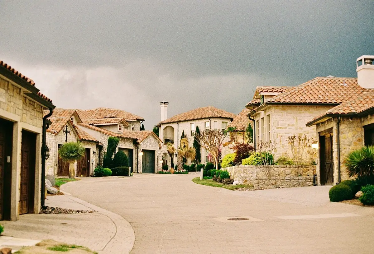Stone cottage-style homes in a Texas Hill Country neighborhood (representative stock photo, not this specific area)